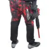 Person in red camo pants with paintball gun.