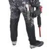 Paintball player with marker in pants pocket.