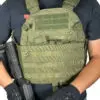 Person wearing a green tactical vest.