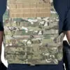 Camouflage tactical vest with molle webbing.