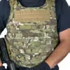 Camouflage tactical vest with molle webbing.