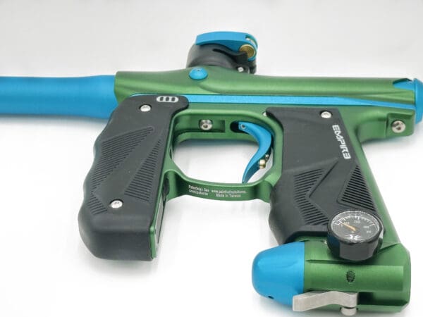 Green and blue paintball marker gun.