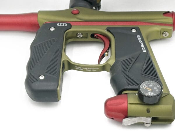 Green and red paintball gun with gauge.