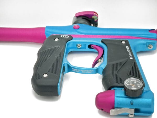 Blue and pink paintball gun with gauge.