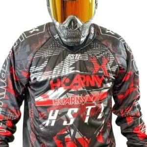 Paintball player in protective gear and jersey.