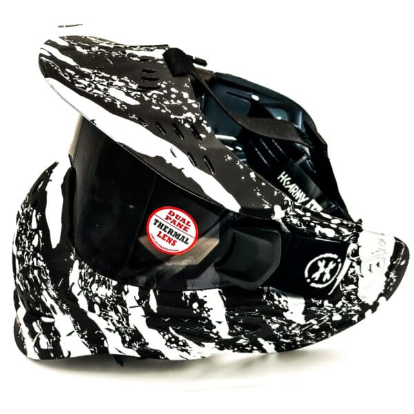 Black and white paintball mask with thermal lens.