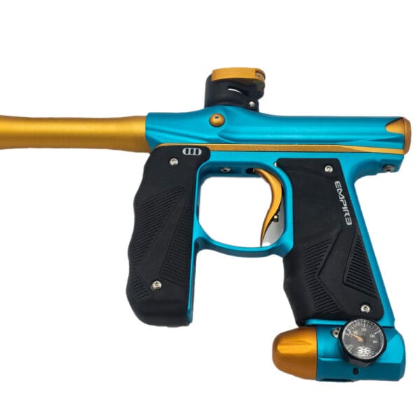 Here's an alt tag for the image: Empire paintball marker, teal and gold.