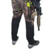 Person in camo pants holding an AR-15.