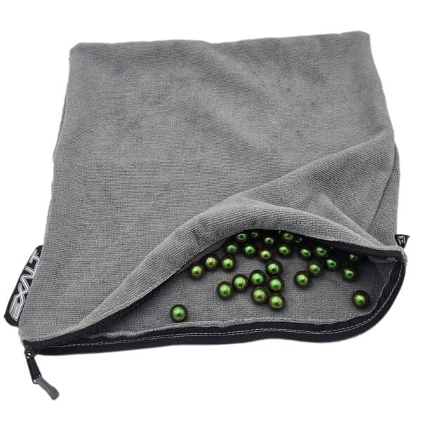 Gray zippered bag filled with green beads.