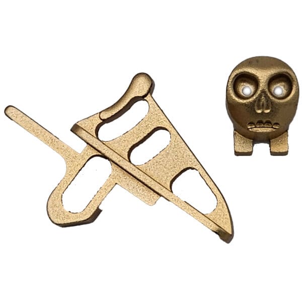 Gold watch parts: skull and lever.