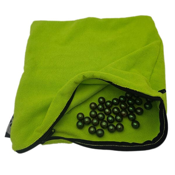 Green bag with dark pearls inside.