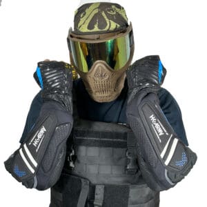 Person wearing paintball gear and elbow pads.