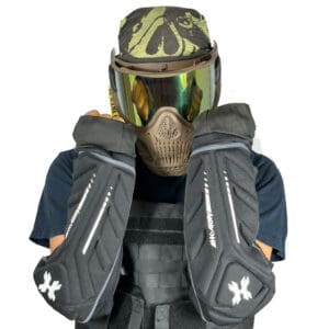 Person wearing paintball gear and elbow pads.