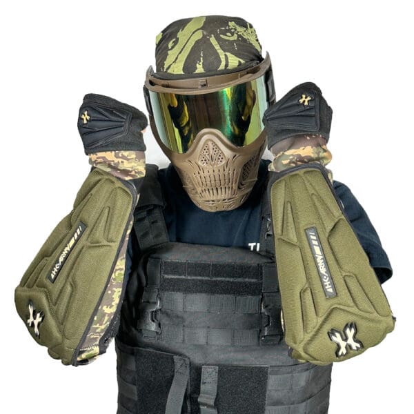 Person wearing paintball gear with elbow pads.