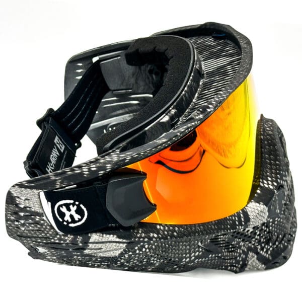 Black and gray paintball mask with orange lens.