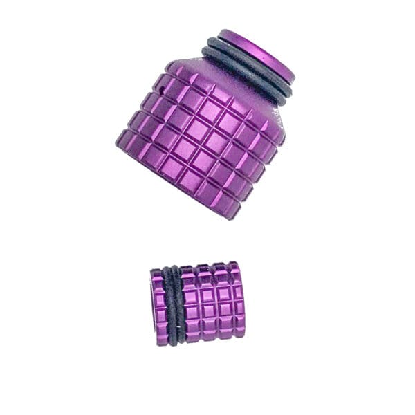 Purple metal bottle caps with a square pattern.