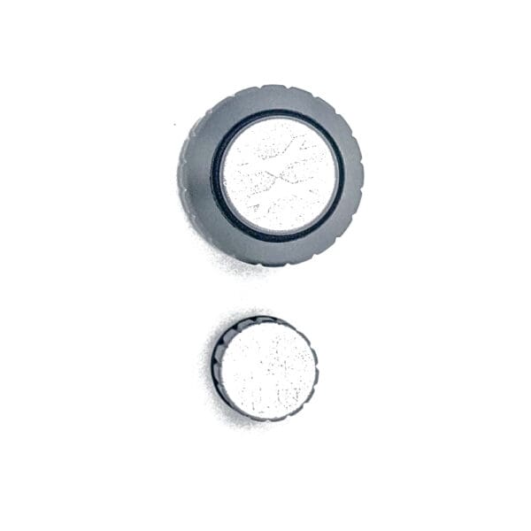 Two black round knobs with white centers.