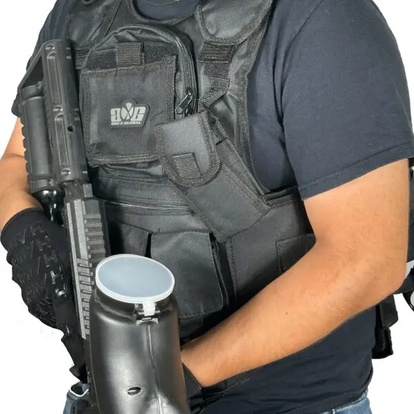 Person wearing a tactical vest with a paintball gun.