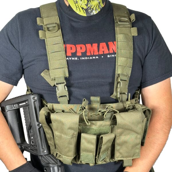 Person wearing a green tactical vest.