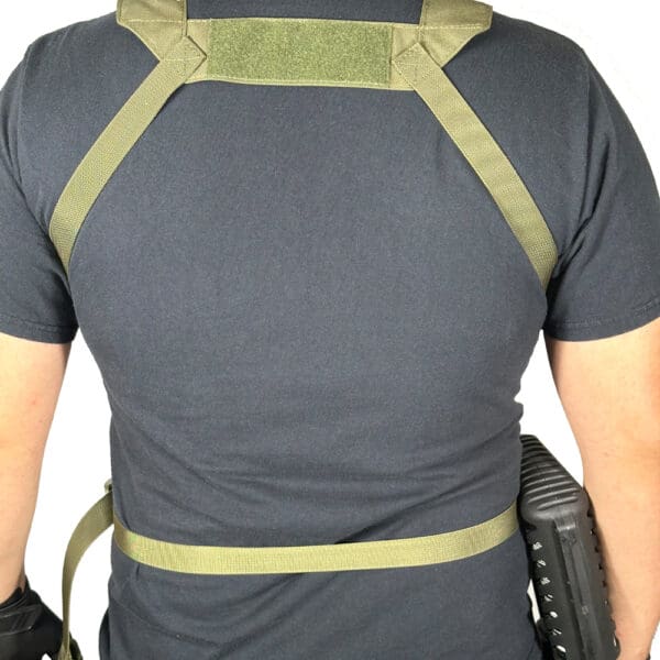 Person wearing a green tactical harness.