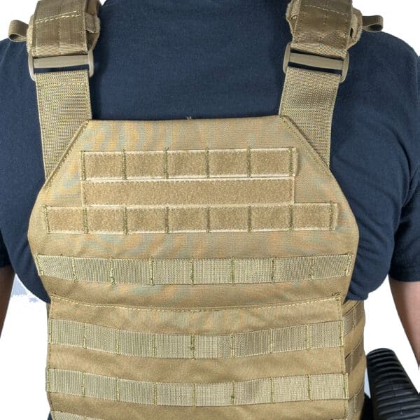 Tan tactical vest with straps and molle.