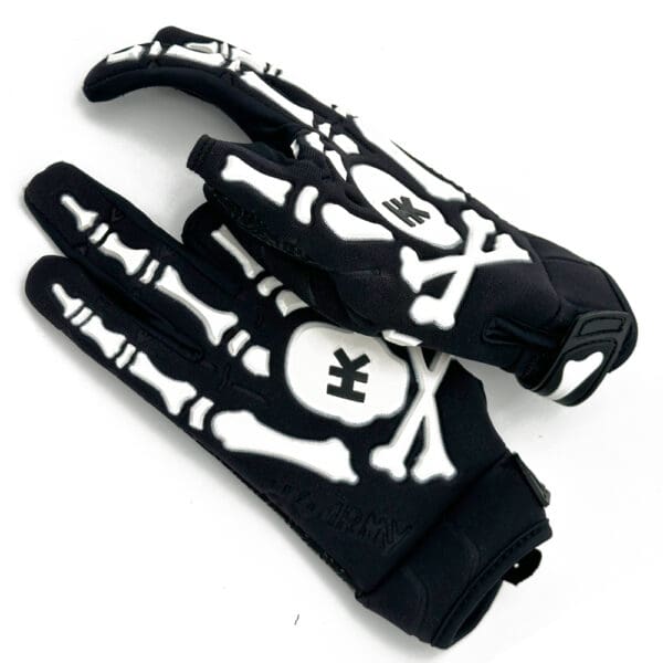 Black and white skeleton gloves with skull logo.