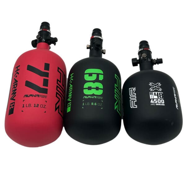 Three AlphaAir paintball air tanks.