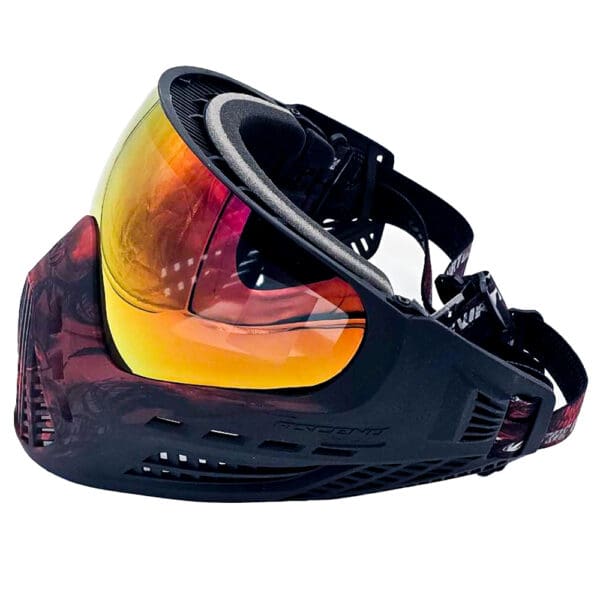 Black paintball mask with orange lens.