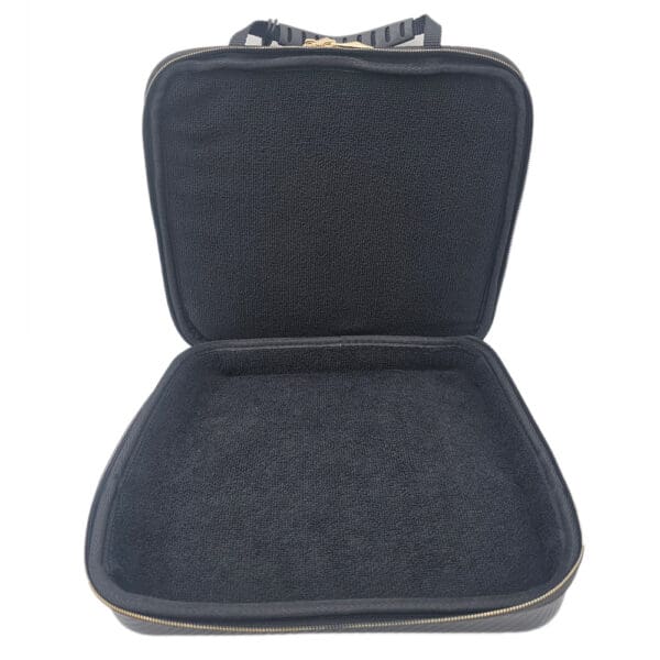 Open black carrying case with soft lining.