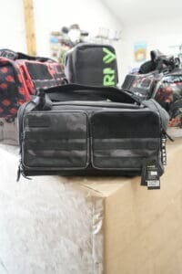 Black duffel bag on display table.