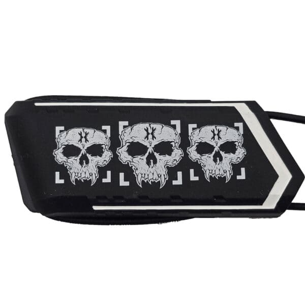 Black object with three white skulls design.