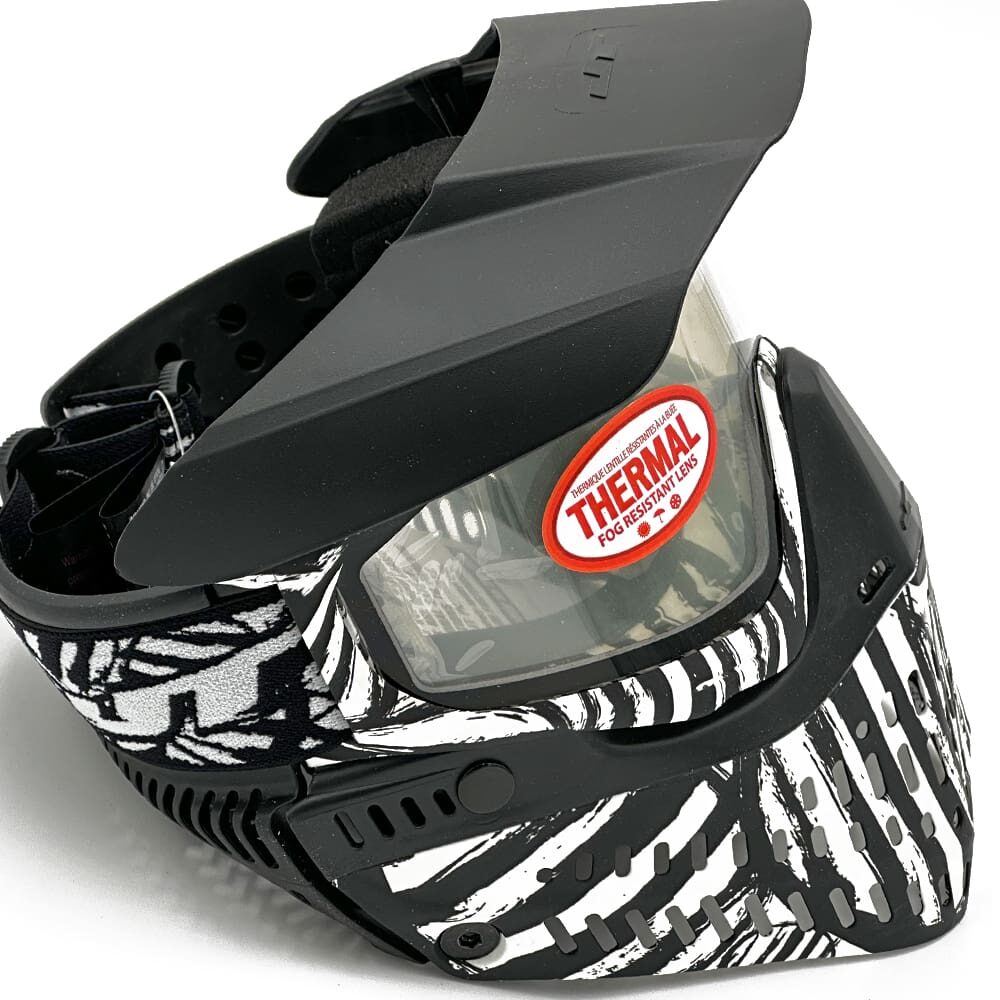 Black and white paintball mask with thermal lens.