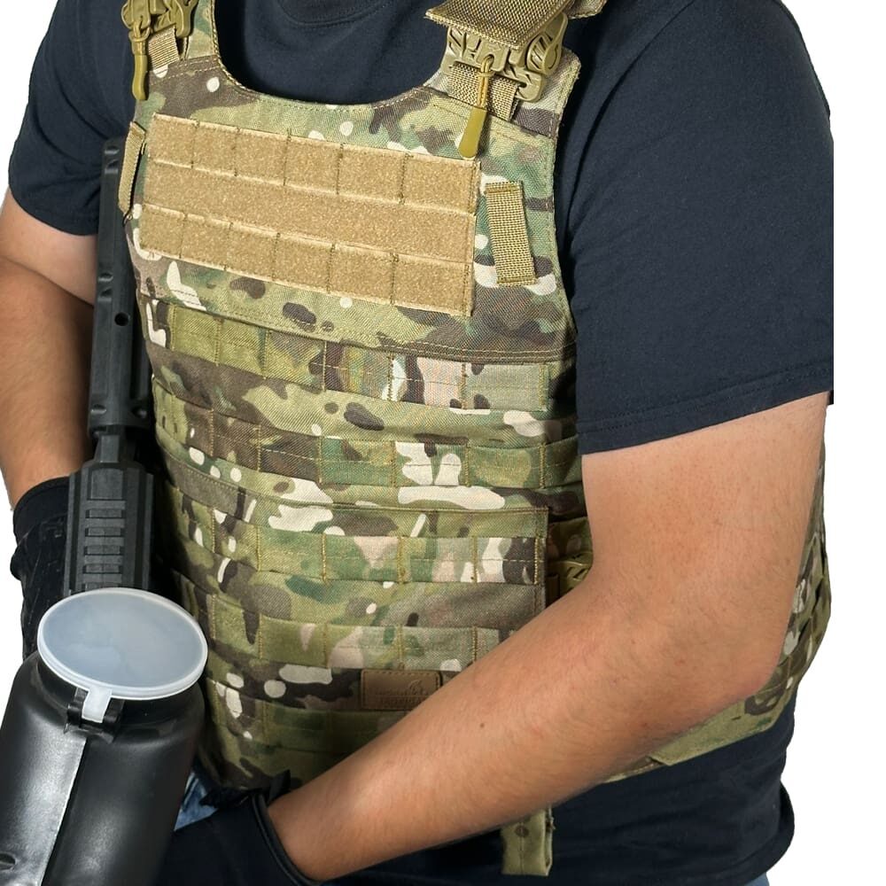 Person wearing a camouflage tactical vest.